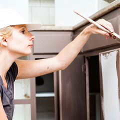 woman painting cabinets