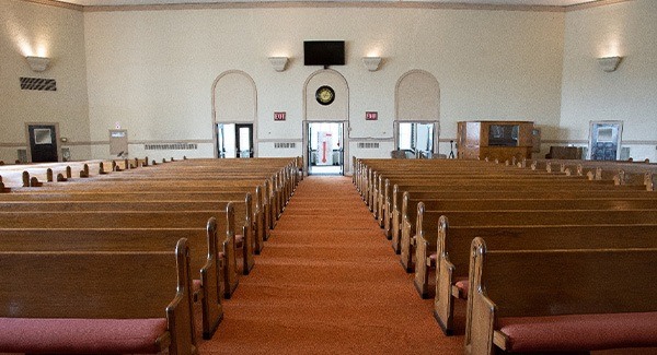 The interior of a church with wooden pews