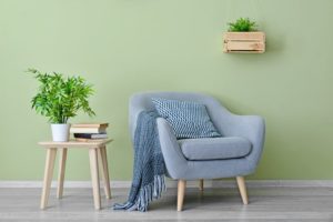 painted room with a chair and a side table in it