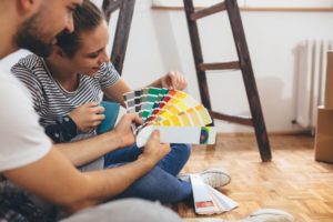 a couple picking out paint colors for their living room