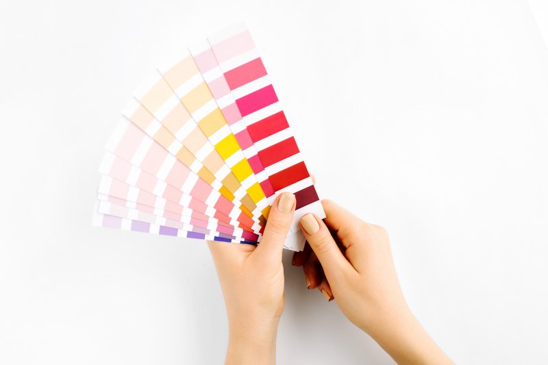 young woman holding color swatches