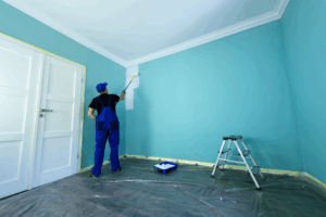a person painting an interior room