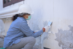 a homeowner removing old paint